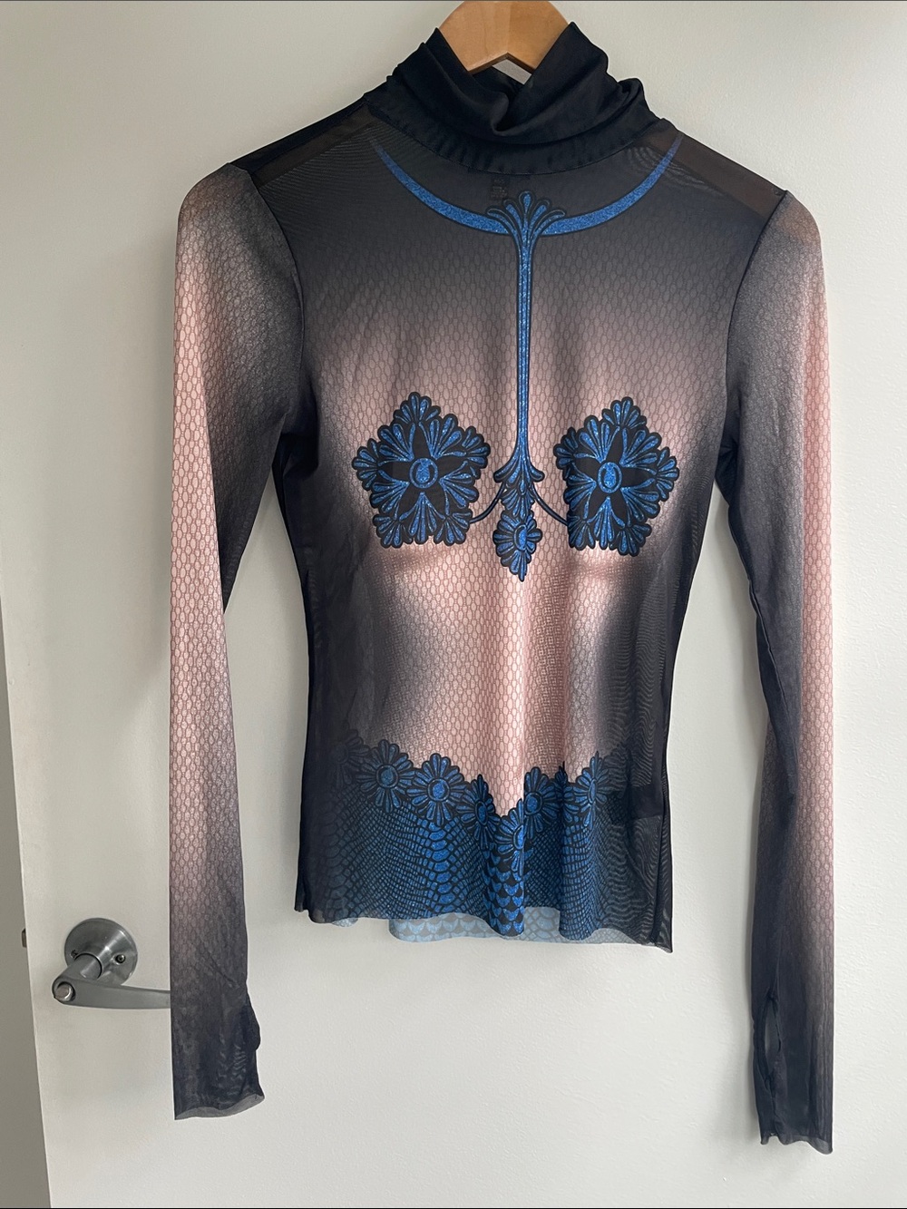 AFRM Sheer Black Long-Sleeve Turtleneck Top with Blue Floral Embroidery Print.